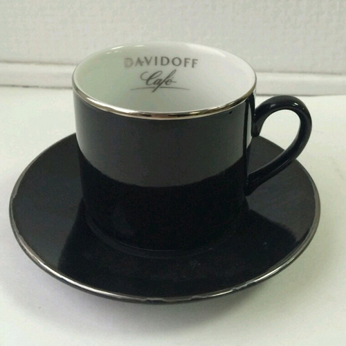 black cup and saucer with silver rim
