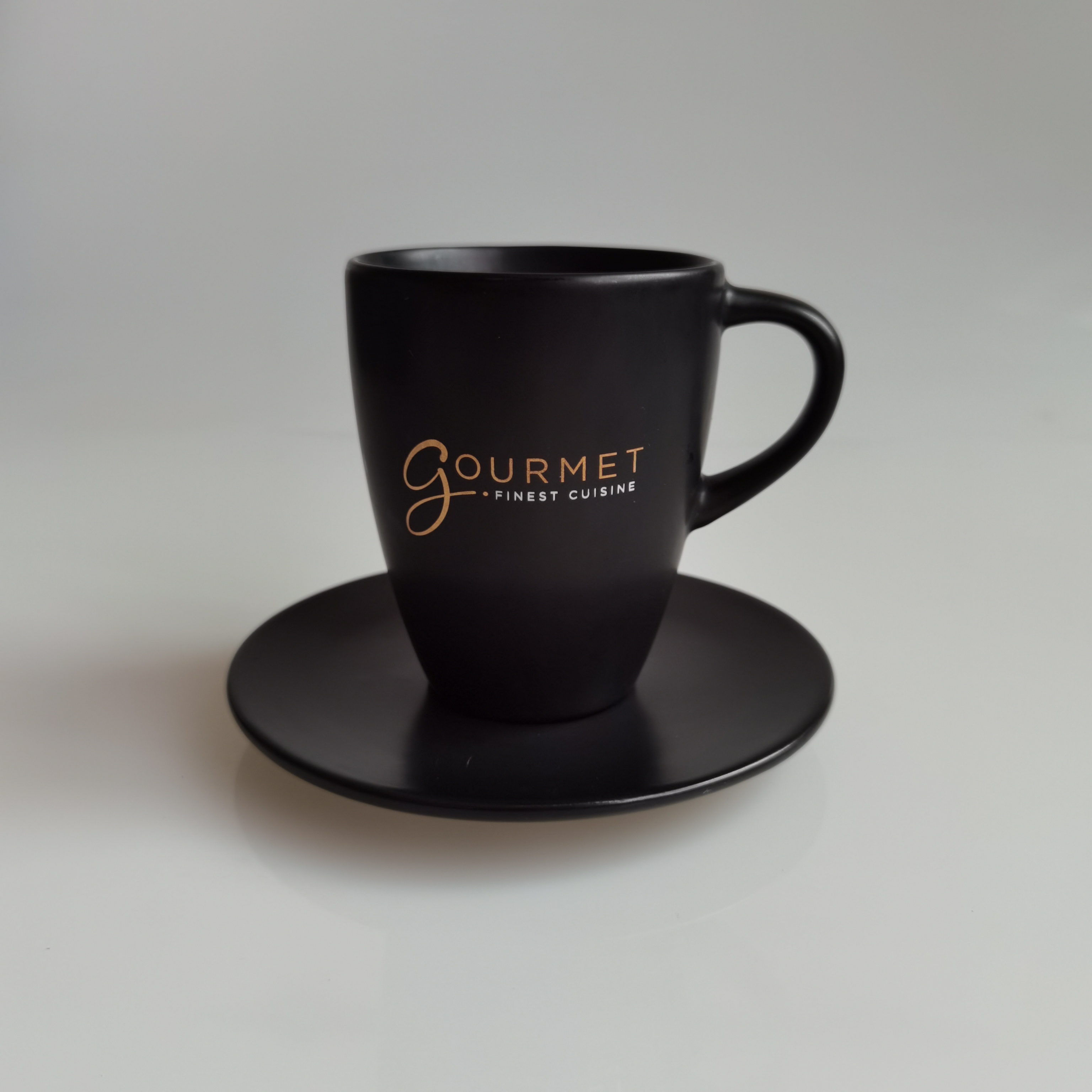 Matt black cup and saucer